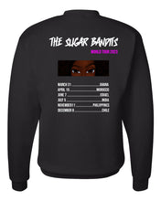 Load image into Gallery viewer, The back of a black crewneck sweater has The Sugar Bandits written horizontally in white at the top and World Tour 2023 written in hot pink centered under the word Bandits. There is an image of just The Sugar Bandits Bandit’s eyes centered underneath and below that are the tour dates and places they’ll visit on the tour. 
