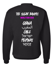 Load image into Gallery viewer, The back of a black crewneck sweater has The Sugar Bandits written in white across the top center, World Tour 2020 is written in hot pink underneath that. Then centered down the middle below that are all written in white are the tour stops: Ghana, Morocco written in Arabic, Chile, Israel written in Hebrew, the Philippines written in Tagalog, and India written in Hindi.
