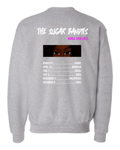 The back of a heather gray crewneck sweater has The Sugar Bandits written horizontally in white at the top and World Tour 2023 written in hot pink centered under the word Bandit. There is an image of just The Sugar Bandits Bandit’s eyes centered underneath and below that are the tour dates and places they’ll visit on the tour. 